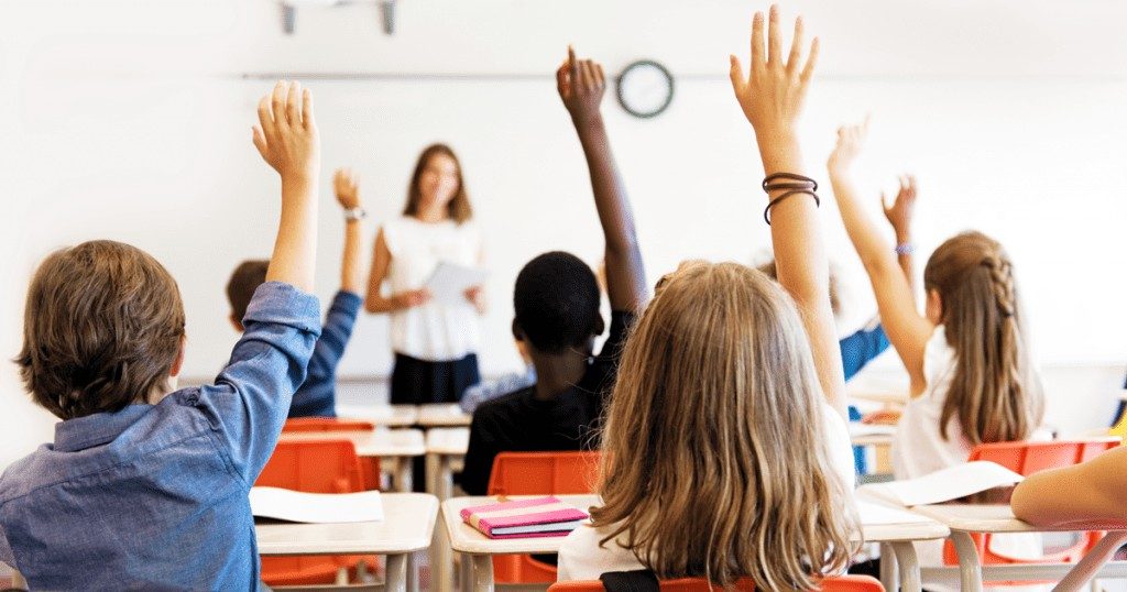 students raising hands