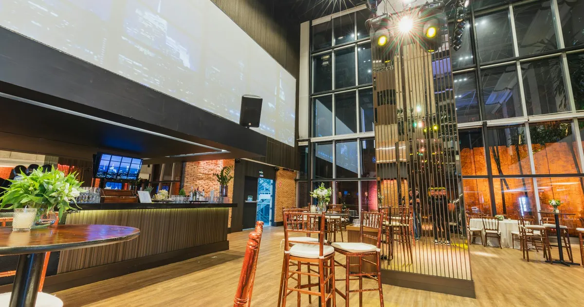 Stylish and elegant restaurant interior featuring a modern bar, decorative lighting, and sleek furniture setup.