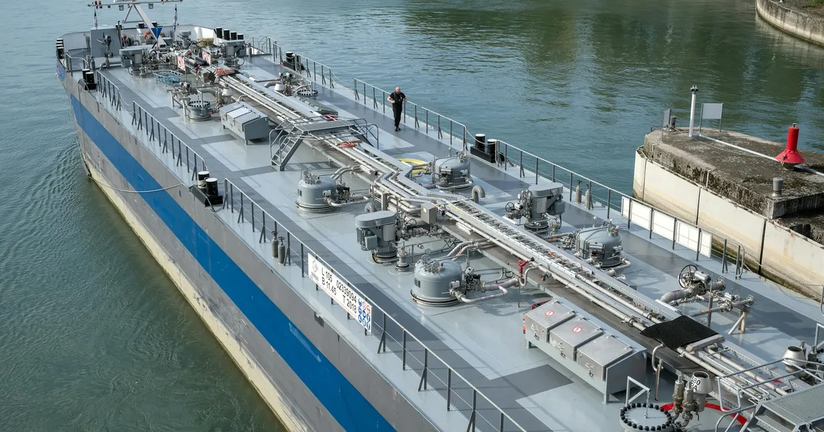 Aerial view of an industrial oil tanker docked at a harbor, showcasing modern maritime technology.