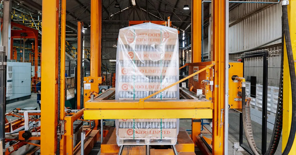 An industrial machine in a glass factory showcasing automated packaging in Dar es Salaam.