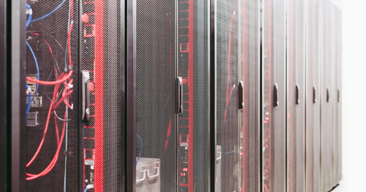 Modern data server room with network racks and cables.